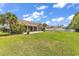 Exterior view of a home's spacious backyard with a screened in porch and lush green grass at 389 Barton Loop, Myrtle Beach, SC 29579