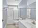 Clean bathroom with tub-shower combo, a white vanity, and neutral tile flooring at 389 Barton Loop, Myrtle Beach, SC 29579