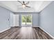 Bedroom with a tray ceiling, ceiling fan, vinyl flooring, and access to an outdoor patio at 389 Barton Loop, Myrtle Beach, SC 29579