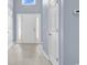 Bright foyer featuring tile flooring, a white front door with sidelights, and blue walls at 389 Barton Loop, Myrtle Beach, SC 29579