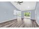 Spacious living room with vaulted ceilings, ceiling fan, and sliding glass doors to the backyard at 389 Barton Loop, Myrtle Beach, SC 29579