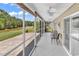 Screened-in porch featuring tile flooring, ceiling fans, and a beautiful lake view at 389 Barton Loop, Myrtle Beach, SC 29579