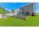 The spacious backyard features a patio, play set, and outdoor seating areas at 396 Emery Oak Dr., Murrells Inlet, SC 29576