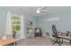 The comfy bedroom features a fan, neutral walls, and lots of light from the window at 396 Emery Oak Dr., Murrells Inlet, SC 29576