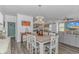 Open dining area connected to living spaces with a wooden table, modern light fixture and view of the living area at 396 Emery Oak Dr., Murrells Inlet, SC 29576