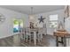 Bright dining room with a stylish table set, modern chandelier, and natural light, perfect for Gathering meals at 396 Emery Oak Dr., Murrells Inlet, SC 29576
