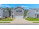 Charming gray two-story home featuring a two-car garage, landscaped front yard, and welcoming curb appeal at 396 Emery Oak Dr., Murrells Inlet, SC 29576