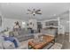 Spacious living room flows to the open kitchen and dining area with an expansive sectional and a ceiling fan at 396 Emery Oak Dr., Murrells Inlet, SC 29576