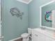 Stylish powder room with decorative fish art, a sleek vanity, and fresh, blue-green paint at 396 Emery Oak Dr., Murrells Inlet, SC 29576