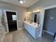 Bathroom with a double sink vanity, tile floors, and large mirror at 4008 Tupelo Ct., Conway, SC 29526