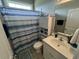 Cozy bathroom with a blue and white striped shower curtain, providing a clean and functional space at 4008 Tupelo Ct., Conway, SC 29526