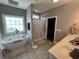 Bathroom with a tub, a walk-in shower, and a double vanity sink at 4008 Tupelo Ct., Conway, SC 29526
