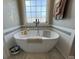 Bathroom featuring a modern soaking tub, a large window, and neutral walls at 4008 Tupelo Ct., Conway, SC 29526