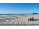 Inviting beach scene with sun umbrella and lounge chairs, perfect for relaxing by the ocean and enjoying the view at 4008 Tupelo Ct., Conway, SC 29526