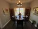 Dining room with decorative chandelier, large window, and wood floors at 4008 Tupelo Ct., Conway, SC 29526