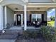 Charming front porch with brick accents and cozy seating, creating a welcoming and inviting entrance at 4008 Tupelo Ct., Conway, SC 29526
