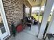 Charming covered front porch with brick detail and comfortable seating, great for relaxing at 4008 Tupelo Ct., Conway, SC 29526