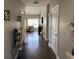 Inviting hallway with hardwood floors leads to a sunlit living area, showcasing elegant decor and open space at 4008 Tupelo Ct., Conway, SC 29526