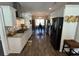 Modern kitchen with stainless steel appliances, white cabinets, wood floors, and a view to the dining area at 4008 Tupelo Ct., Conway, SC 29526