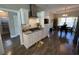 Modern kitchen with stainless steel appliances, white cabinets, wood floors, and a view to the dining area at 4008 Tupelo Ct., Conway, SC 29526