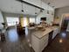 Open kitchen view with an island, bar seating, a sink, stainless steel dishwasher, and a view into the living room at 4008 Tupelo Ct., Conway, SC 29526