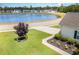 Community pond view featuring a well maintained lawn and decorative shrubbery at 404 Windermere Lake Circle, Conway, SC 29526