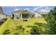 Expansive backyard with manicured lawn, fire pit, patio with grill, and screened in porch at 404 Windermere Lake Circle, Conway, SC 29526