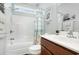 Clean bathroom showcasing a shower-tub combo, vanity with stylish mirror, and beach-themed decor for a refreshing ambiance at 404 Windermere Lake Circle, Conway, SC 29526