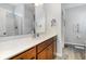 Bathroom featuring a spacious vanity with wood cabinets and a walk-in shower at 404 Windermere Lake Circle, Conway, SC 29526