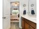 This bathroom opens into a bedroom that features a ceiling fan and natural light at 404 Windermere Lake Circle, Conway, SC 29526