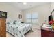 Comfortable bedroom featuring a ceiling fan, a large window, and starfish themed bedding, offering a serene retreat at 404 Windermere Lake Circle, Conway, SC 29526