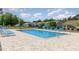 Community pool featuring lounge chairs and tables for relaxing, surrounded by lovely homes at 404 Windermere Lake Circle, Conway, SC 29526
