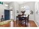 Bright dining room featuring hardwood floors, large windows for natural light, and a stylish chandelier above the table at 404 Windermere Lake Circle, Conway, SC 29526