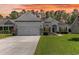 Charming single-story home featuring a well-manicured lawn and an attached two-car garage at 404 Windermere Lake Circle, Conway, SC 29526
