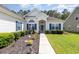 Well-maintained home with manicured landscaping and a walkway leading to the front entrance at 404 Windermere Lake Circle, Conway, SC 29526