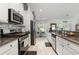 Well-equipped kitchen with stainless steel appliances, granite countertops, white cabinets, and a decorative tile backsplash at 404 Windermere Lake Circle, Conway, SC 29526