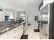 Open concept kitchen with granite counters, white cabinetry, stainless steel appliances, and views to the dining area at 404 Windermere Lake Circle, Conway, SC 29526