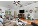 Comfortable living room featuring a vaulted ceiling, a ceiling fan, and a cozy electric fireplace at 404 Windermere Lake Circle, Conway, SC 29526