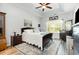 Relaxing main bedroom featuring a dark wood bed set, ceiling fan, and a window providing ample natural light at 404 Windermere Lake Circle, Conway, SC 29526