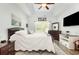 This main bedroom features a tray ceiling, natural light, and a large TV at 404 Windermere Lake Circle, Conway, SC 29526