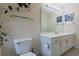 Well-lit bathroom with a vanity, toilet, and decorative hanging plant and art at 4276 Santolina Way # A, Murrells Inlet, SC 29576