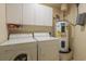 Efficient laundry room featuring a washer, dryer, and water heater with storage cabinets above at 4276 Santolina Way # A, Murrells Inlet, SC 29576