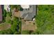 A high-angle aerial photo shows a large backyard surrounded by lush, green trees at 4363 Parkland Dr., Myrtle Beach, SC 29579