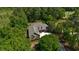 A high aerial shot exhibits the large brick home surrounded by towering trees at 4363 Parkland Dr., Myrtle Beach, SC 29579