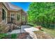 Relaxing backyard brick patio features an iron fence, manicured lawn, and chairs at 4363 Parkland Dr., Myrtle Beach, SC 29579
