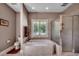 This bathroom features a tub and a glass shower, as well as a window for natural light at 4363 Parkland Dr., Myrtle Beach, SC 29579