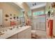 Well-lit bathroom with a vanity, sink, and a shower-tub combination, adorned with fish themed decor at 4363 Parkland Dr., Myrtle Beach, SC 29579