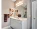 This bathroom features a white vanity with a sink, a large mirror, and a door leading to a shower at 4363 Parkland Dr., Myrtle Beach, SC 29579