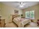 Cozy bedroom with a quaint bed, complemented by floral bedding, a ceiling fan and natural light from the window at 4363 Parkland Dr., Myrtle Beach, SC 29579