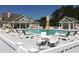 Community pool surrounded by lounge chairs and tables under the sun on the pool deck at 4363 Parkland Dr., Myrtle Beach, SC 29579